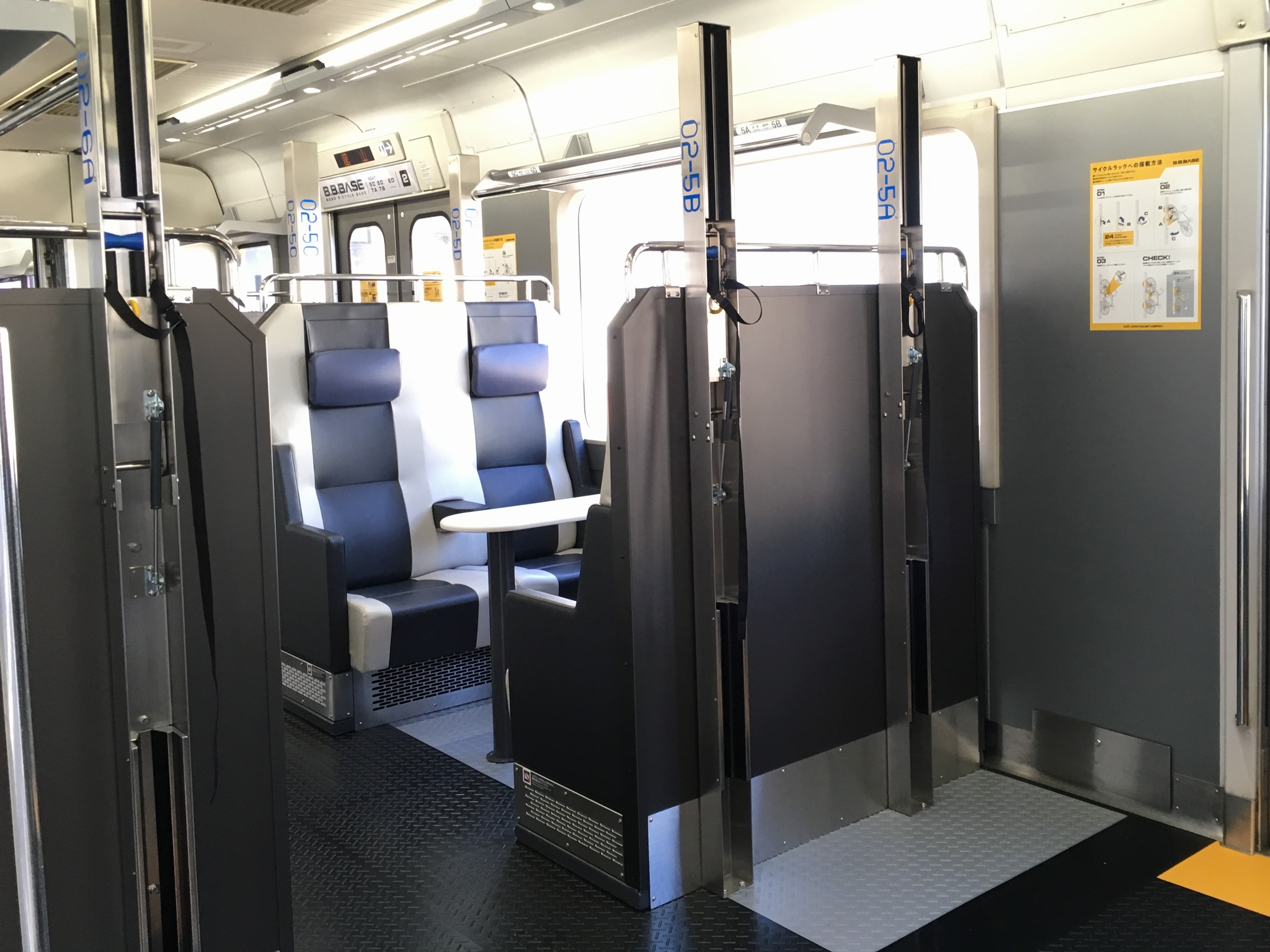 Interior of B.B.BASE with bicycle racks between the seats.