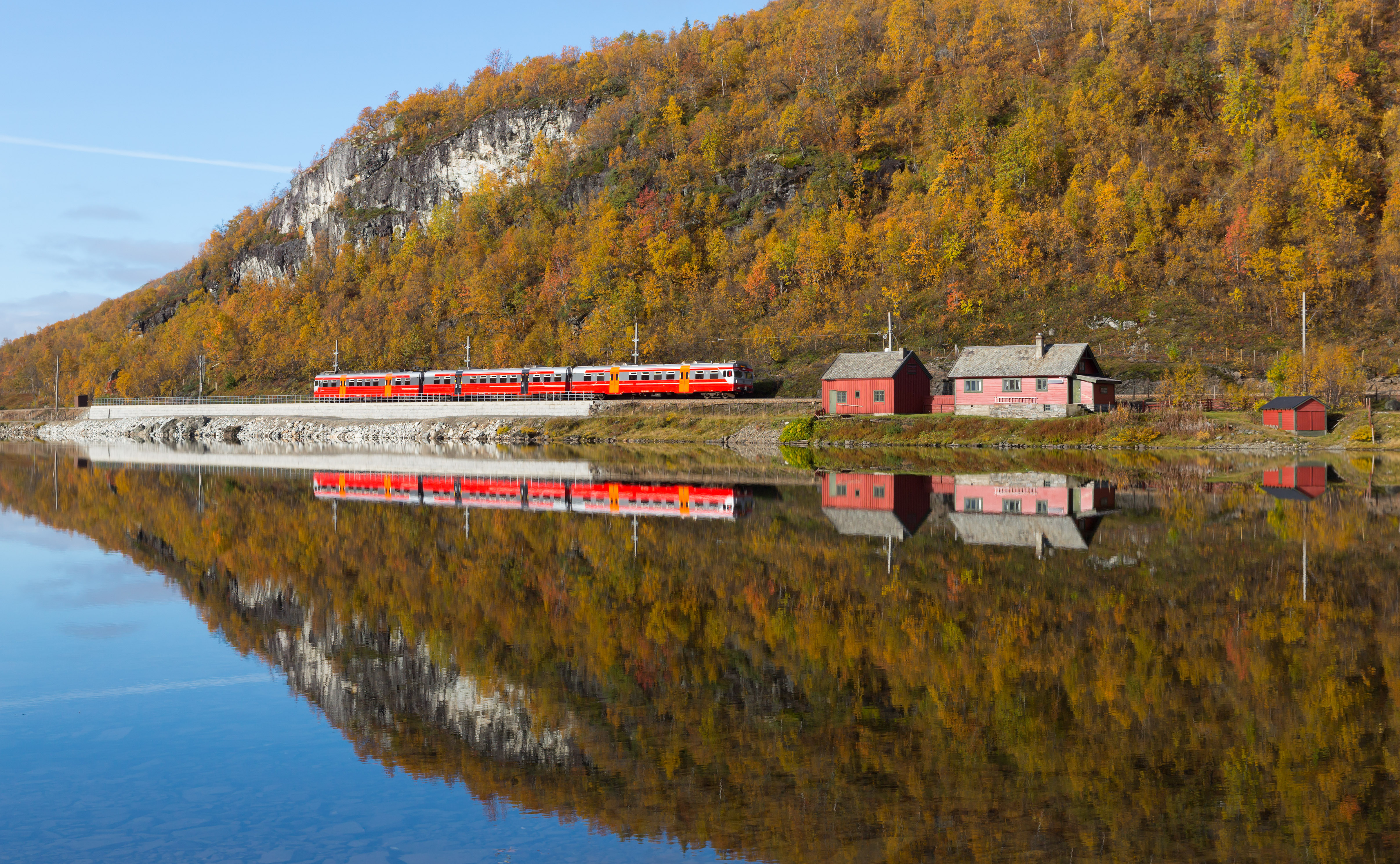 A passenger train on the Bergen Line beside Langavatnet between Vieren and Ørneberget, Norway.