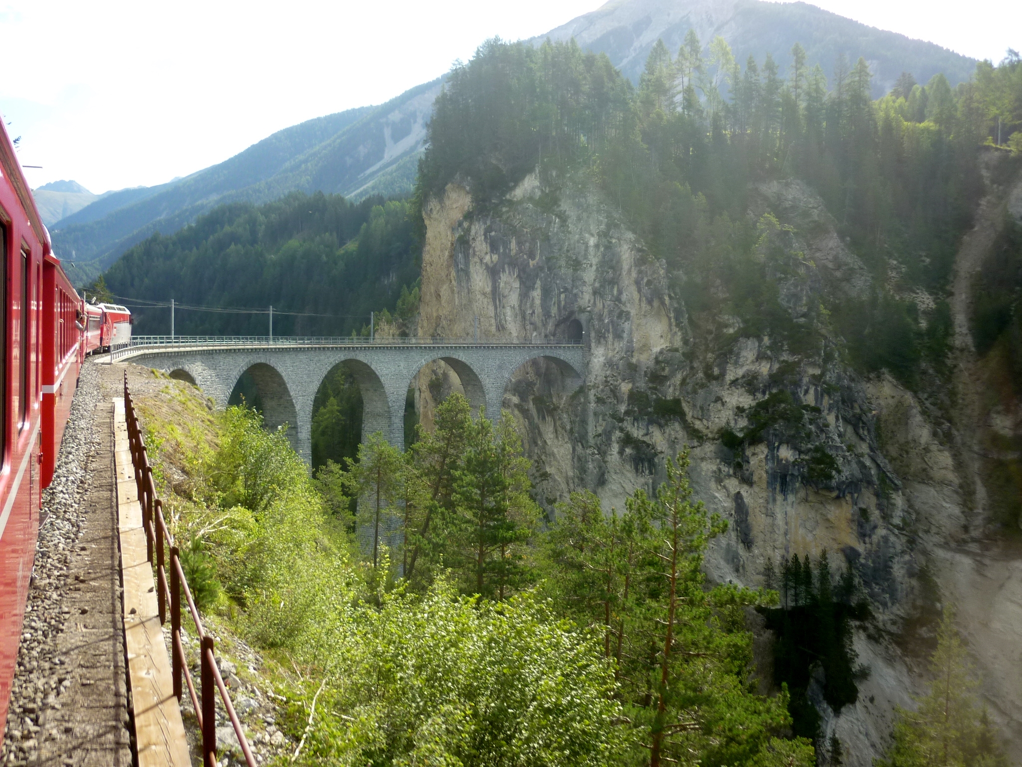 Bernina Express of the Rhaetian Railway crossing the Landwasser Viaduct in Switzerland.
