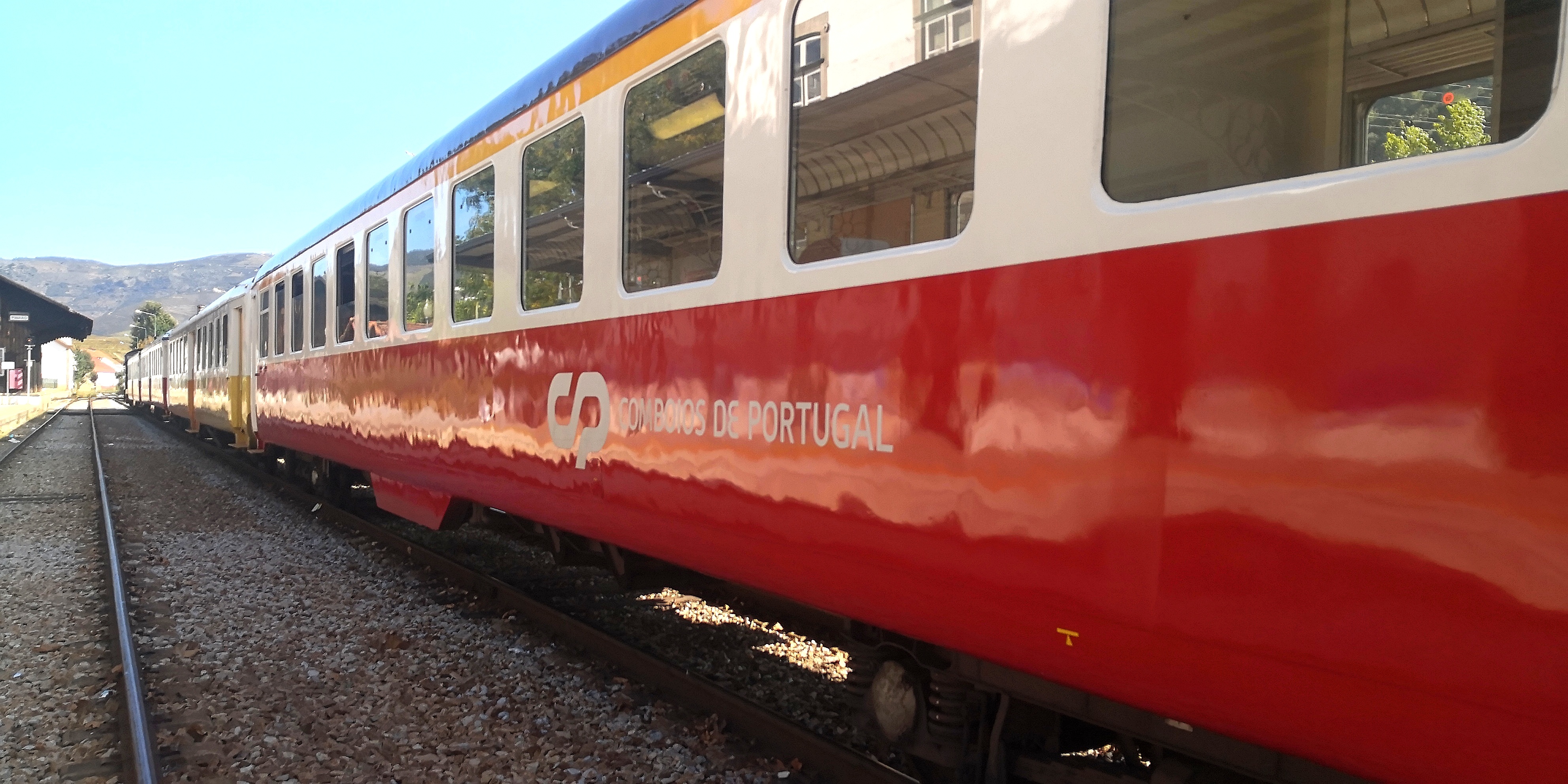 CP InterRegional train on the Douro Line at Pinhão station in Portugal.