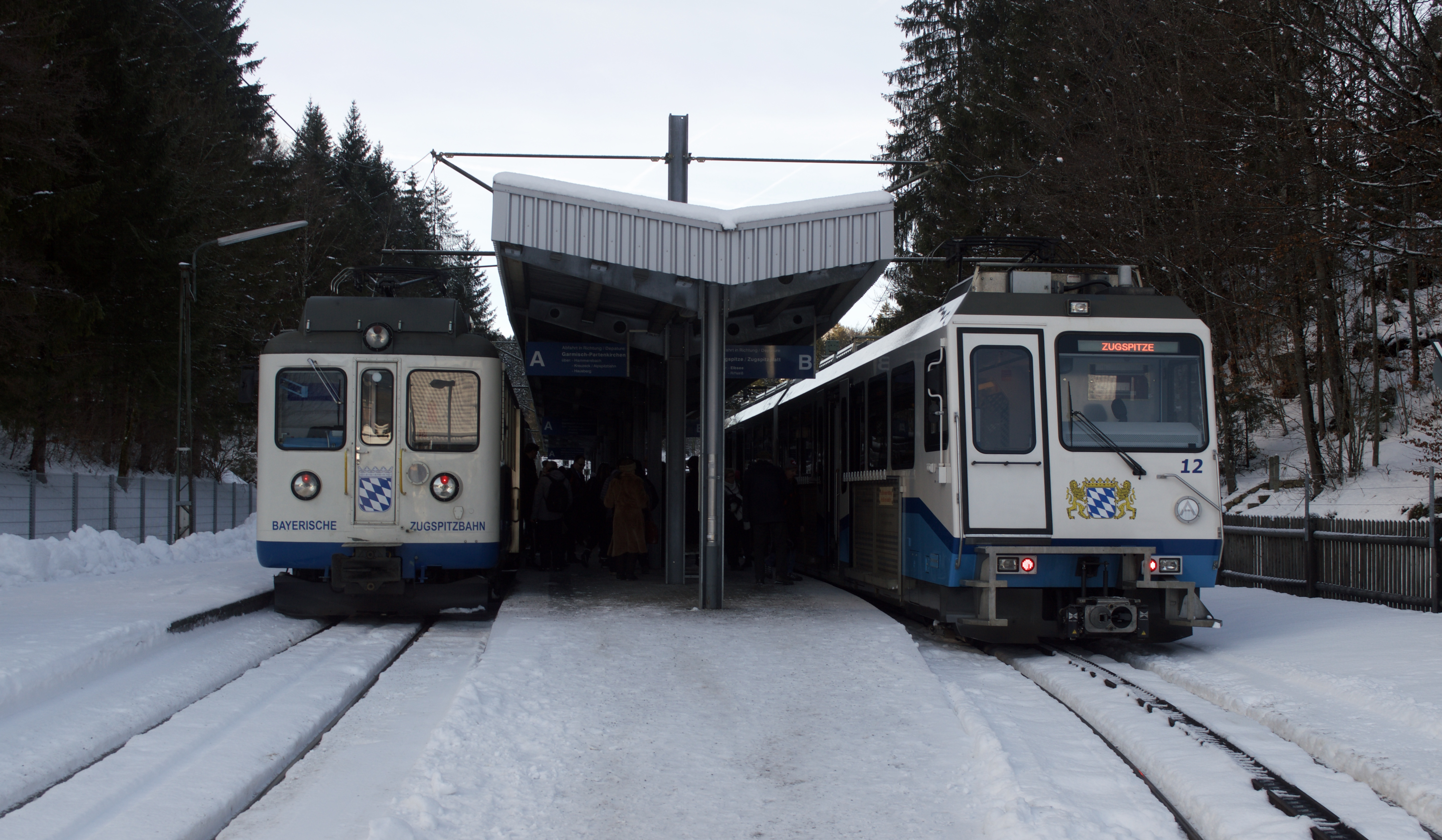 A Bayerische Zugspitzbahn train at Grainau below the snow-covered Wetterstein mountains.