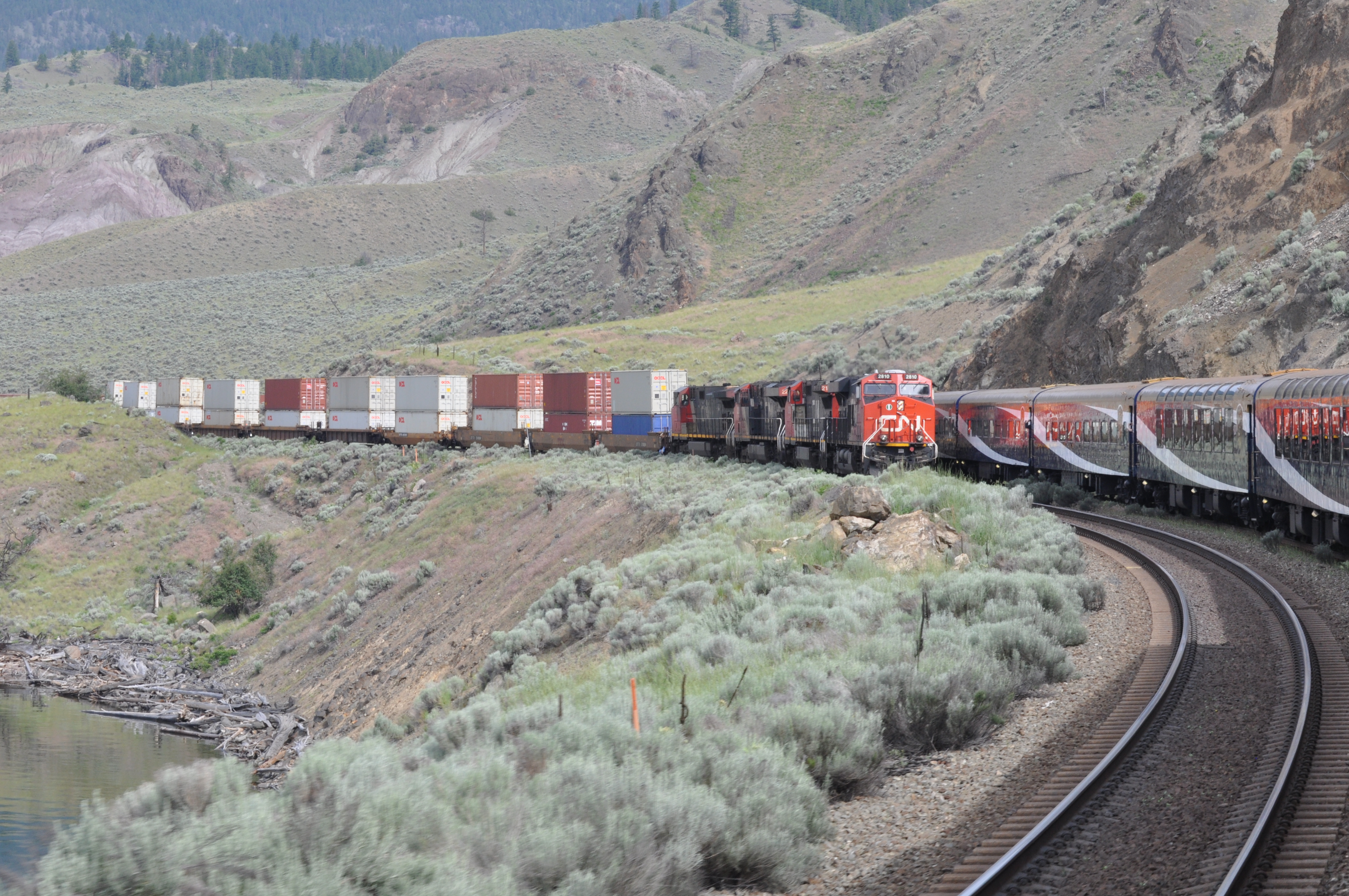 A Rocky Mountaineer train running through the dry canyon country of interior British Columbia.