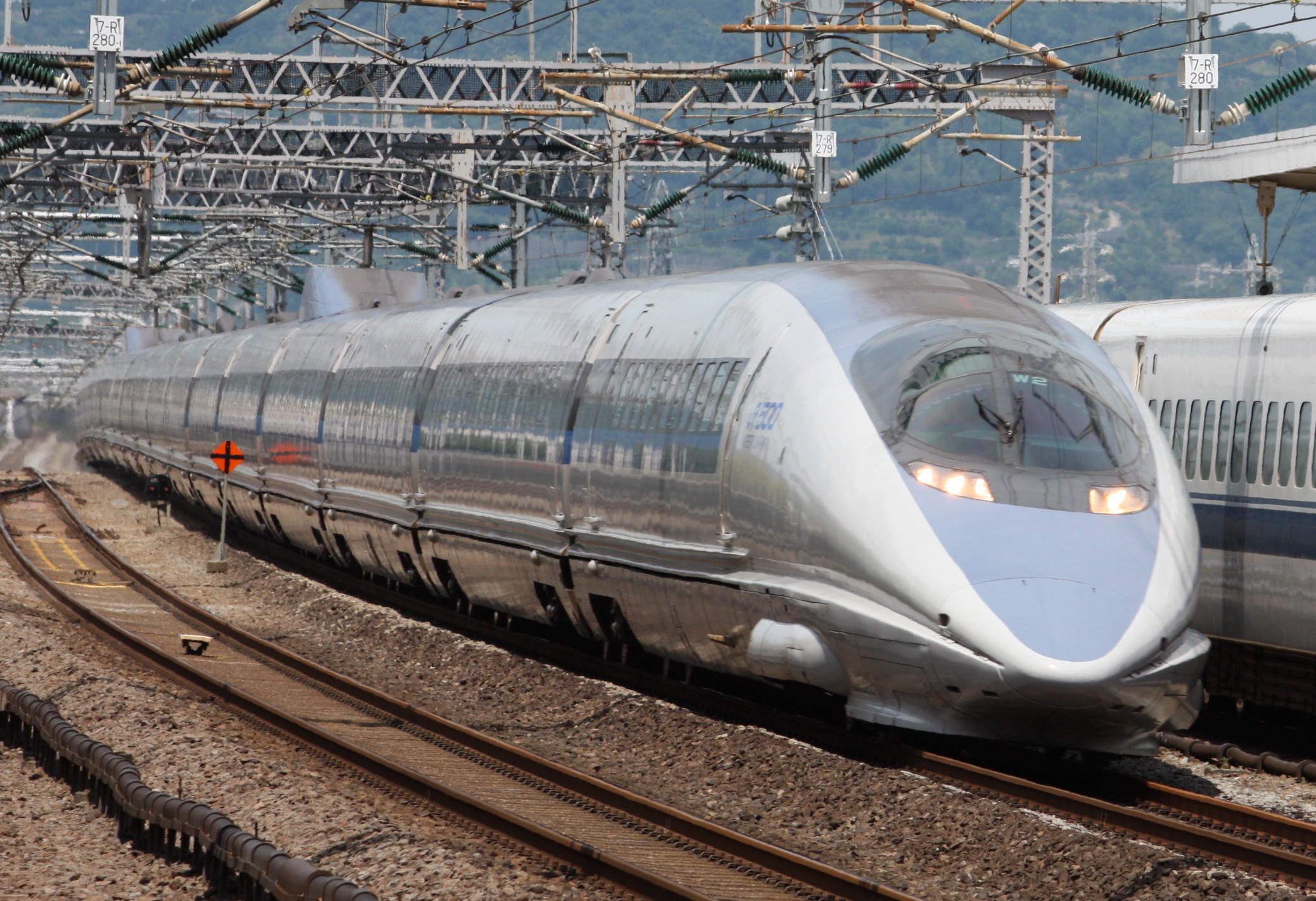 A 500 series Sanyo Shinkansen train runs through the countryside of western Japan.