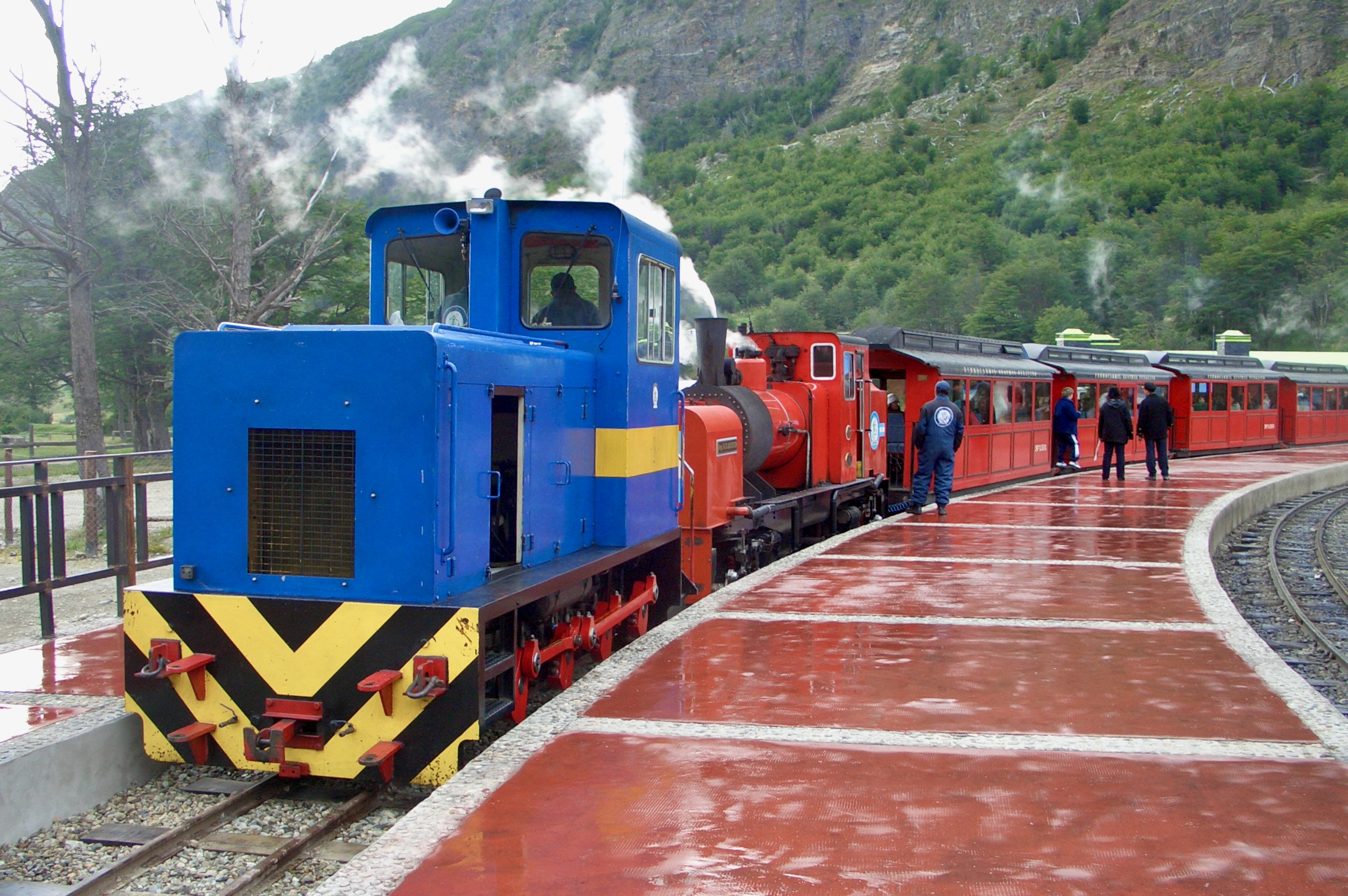 The End of the World Train stands with its coaches beneath the mountains near Ushuaia.