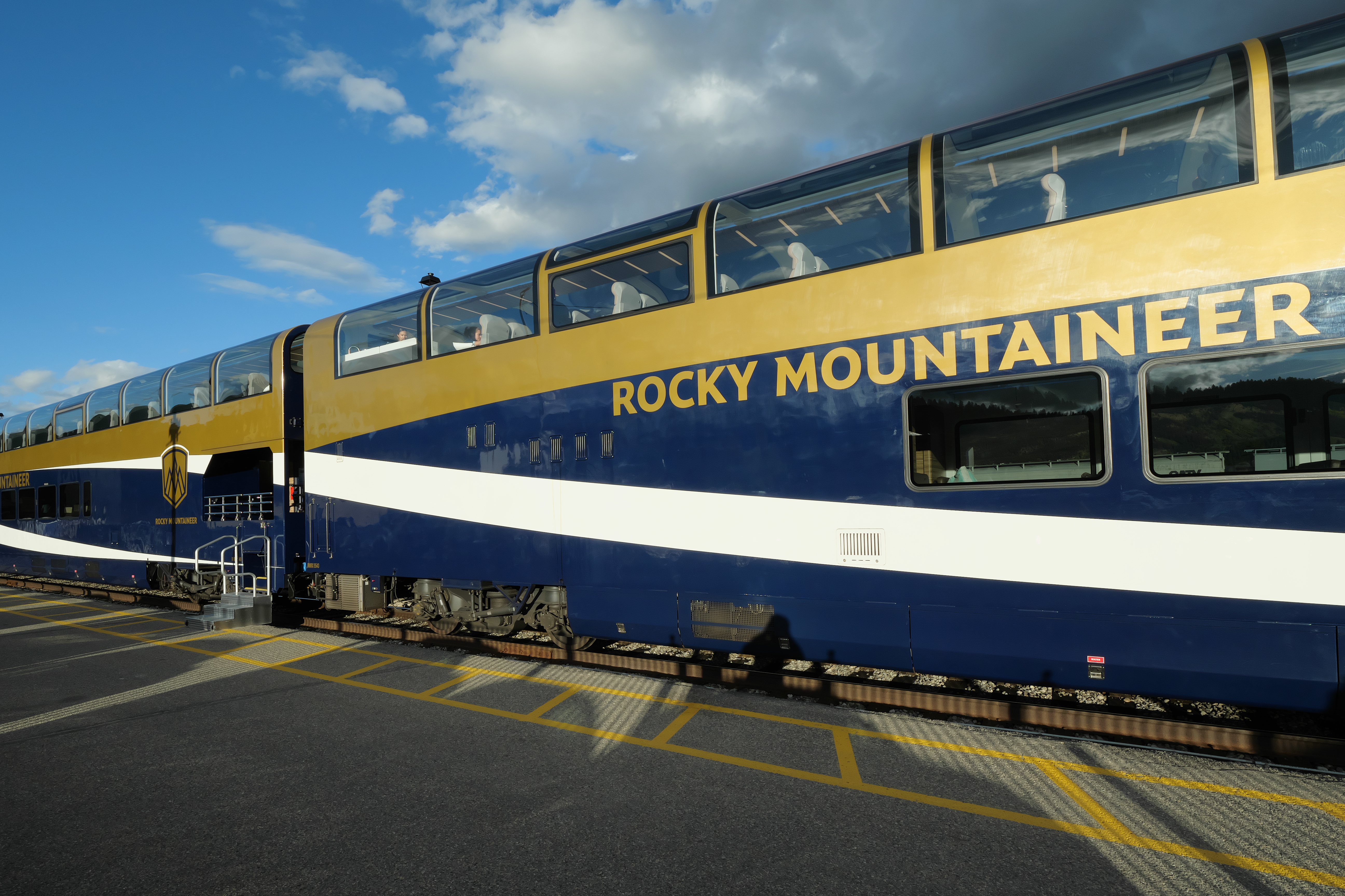 Rocky Mountaineer GoldLeaf panorama coaches at Jasper station in Alberta, terminus of Journey through the Clouds.