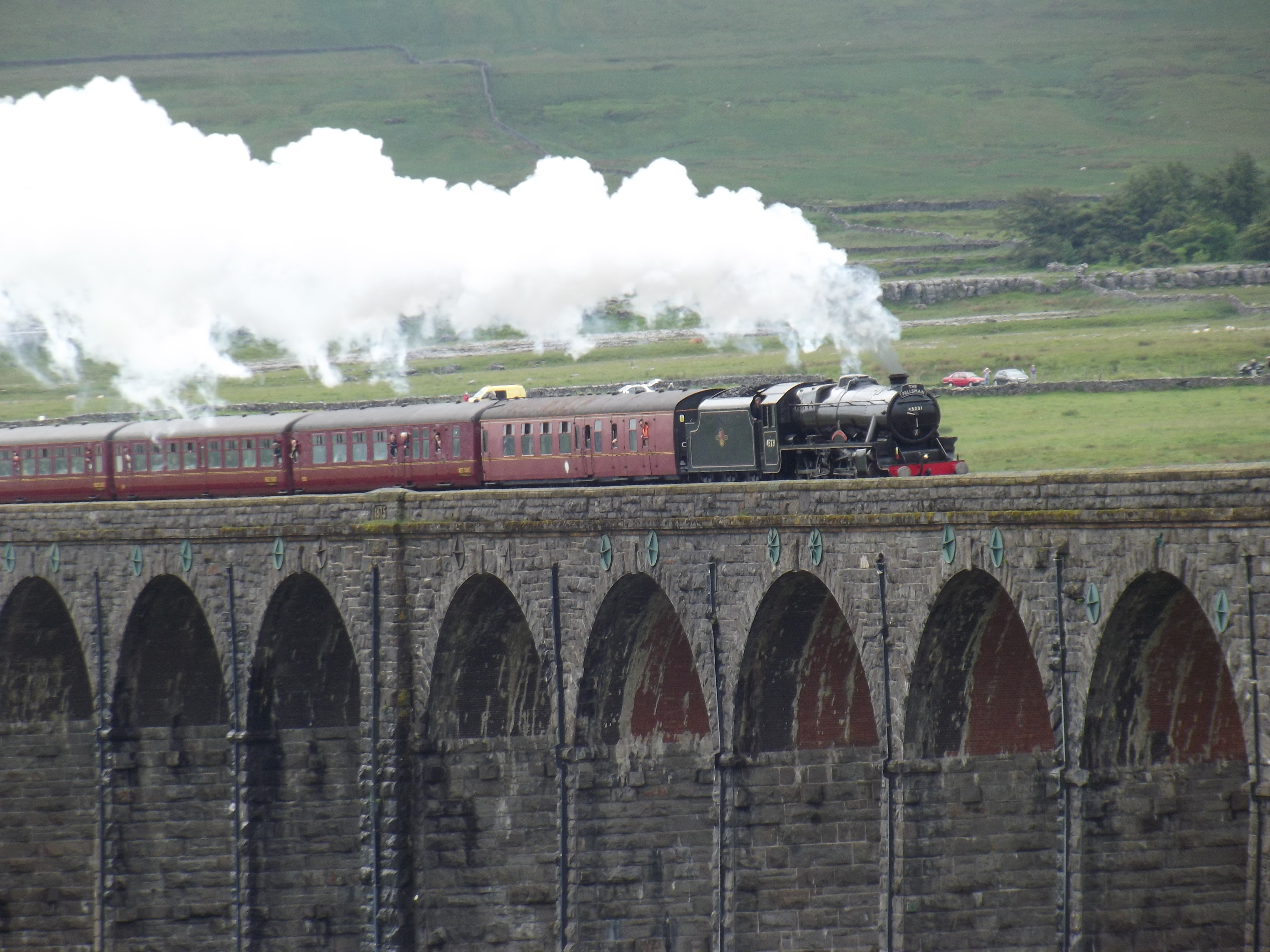 A steam-hauled train crossing Ribblehead Viaduct on the Settle–Carlisle Line in northern England.