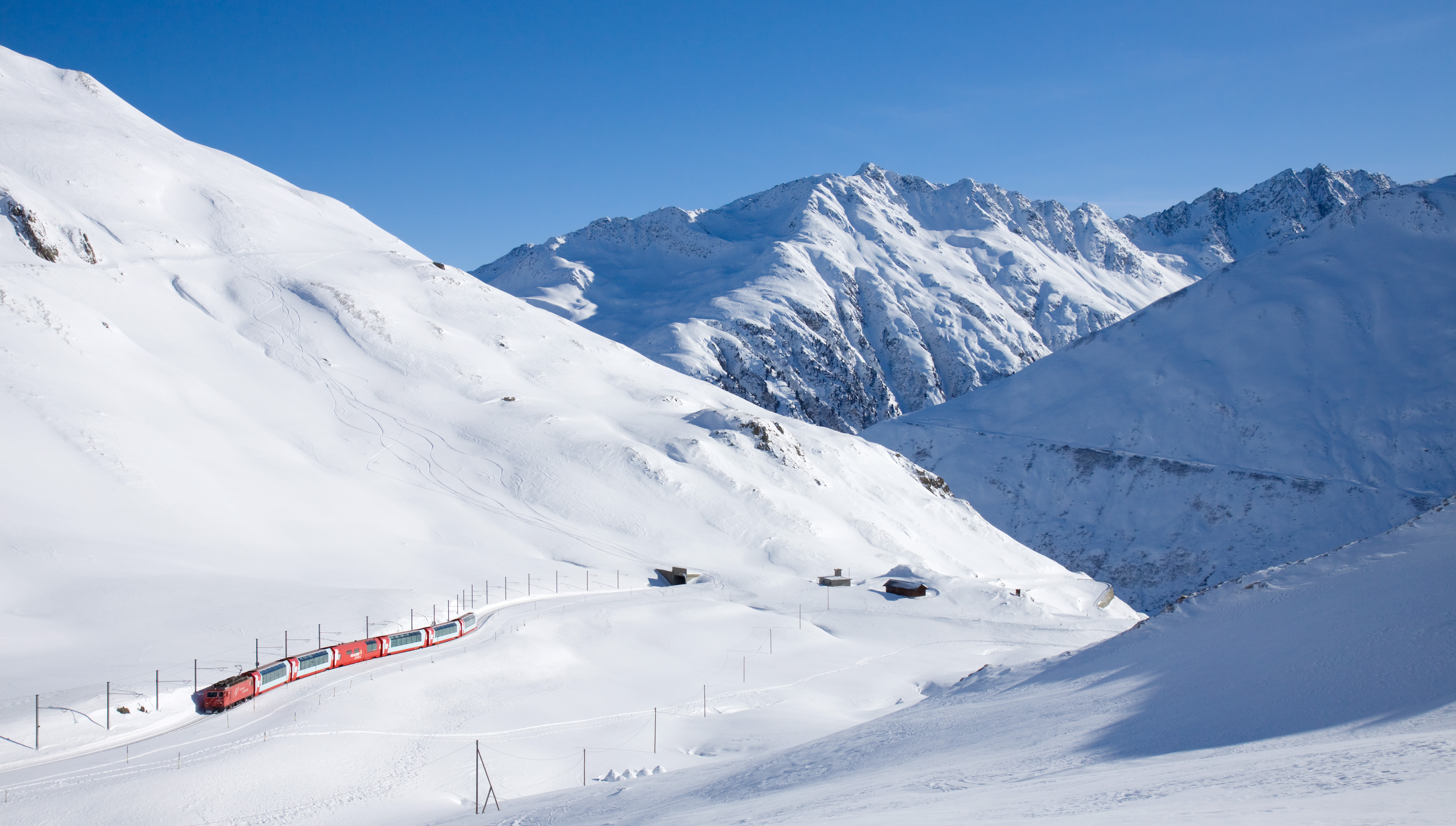 The Glacier Express approaching Oberalp Pass in the Swiss Alps.