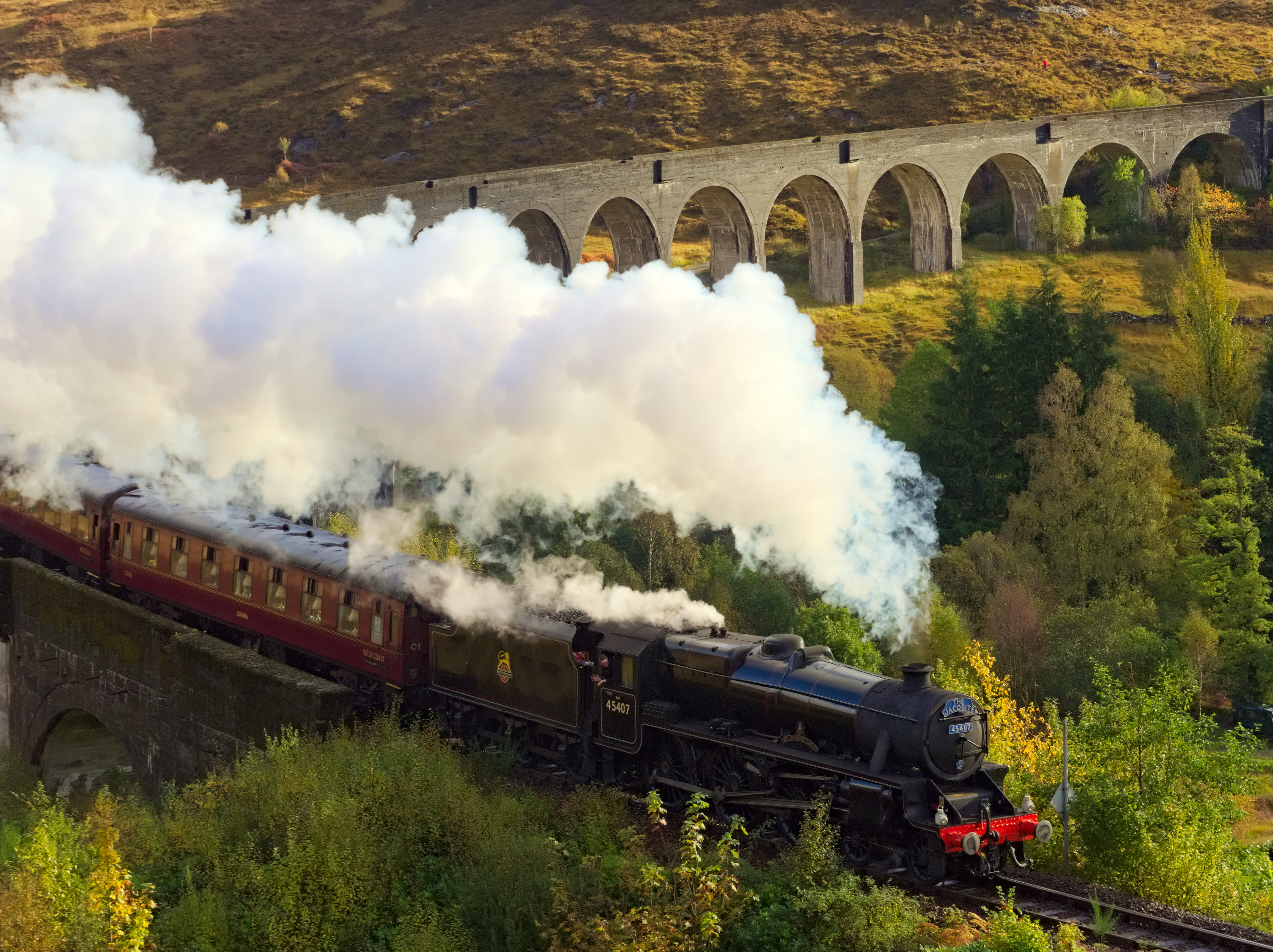The Jacobite steam train crosses the Glenfinnan Viaduct in the Scottish Highlands.