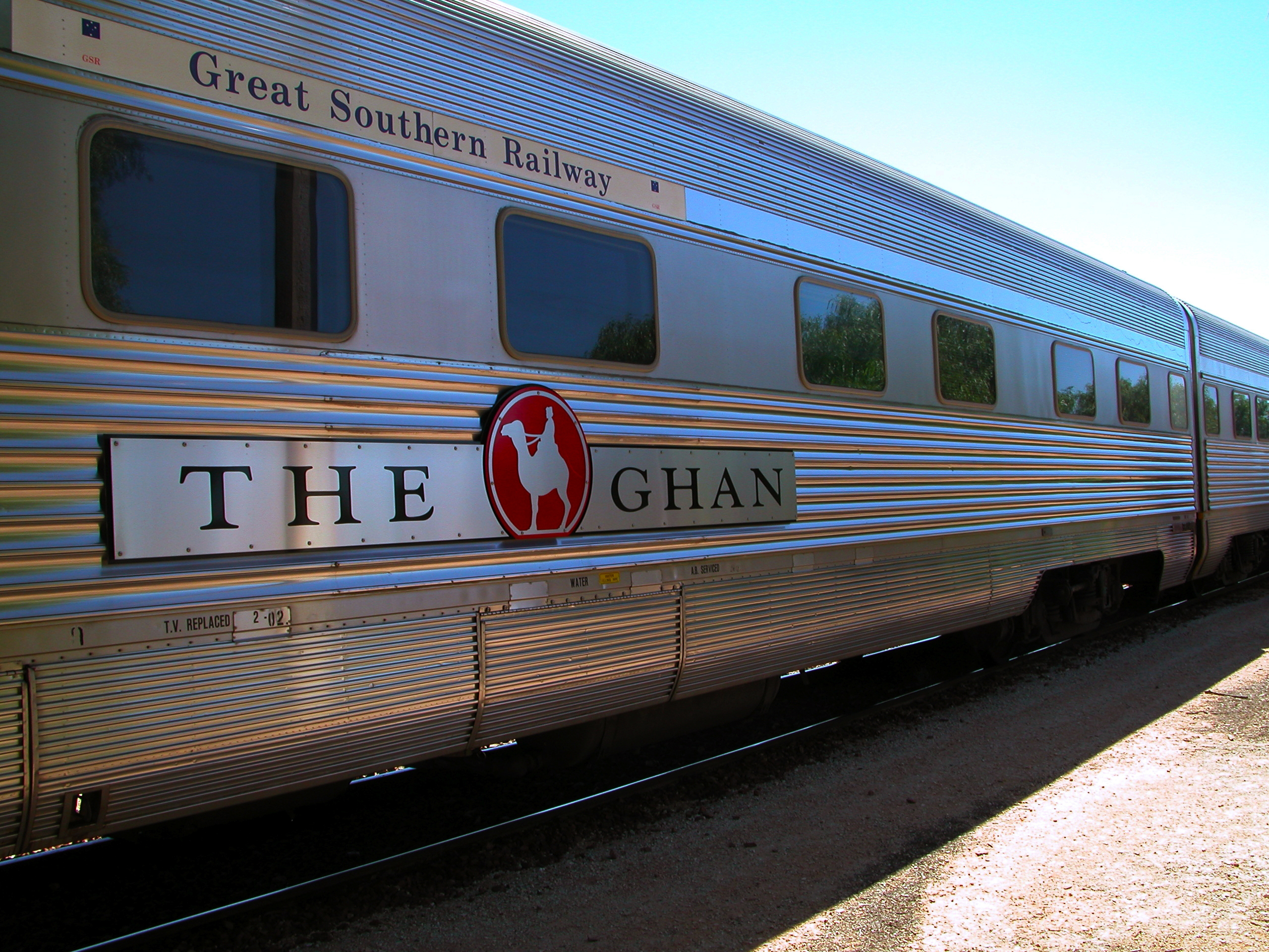 Great Southern: Side view of passenger car with livery of The Ghan train (Great Southern Railway)