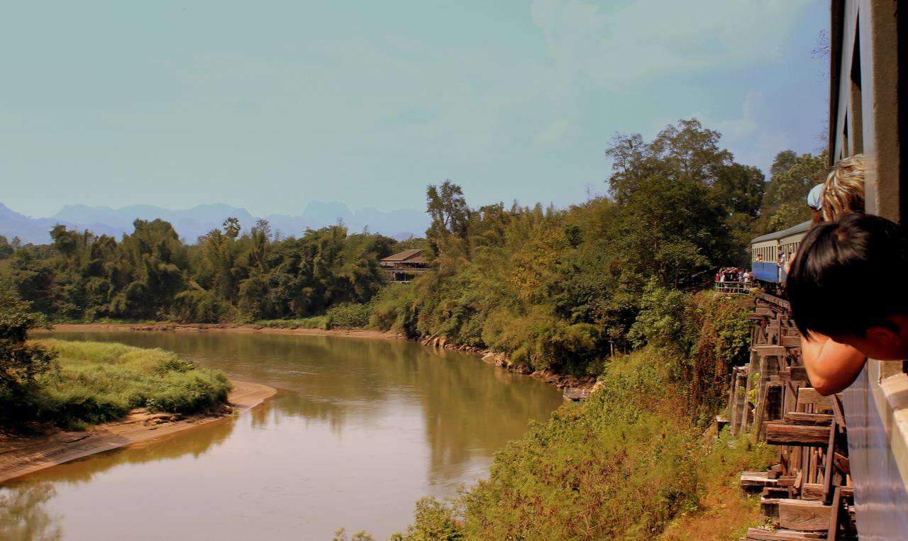 A Thai Railways passenger train crossing Wang Pho Viaduct on the Death Railway en route to Nam Tok in Thailand.