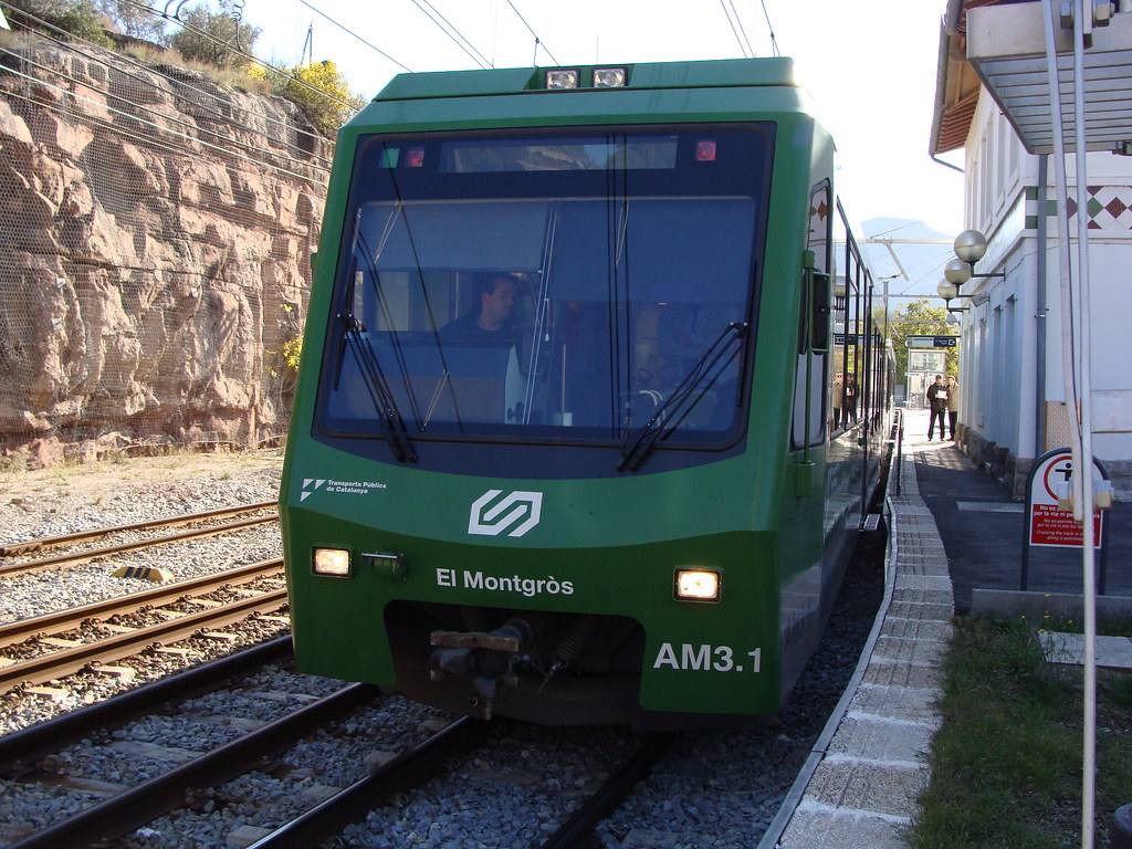 A Cremallera de Montserrat rack railway train below the Montserrat massif.