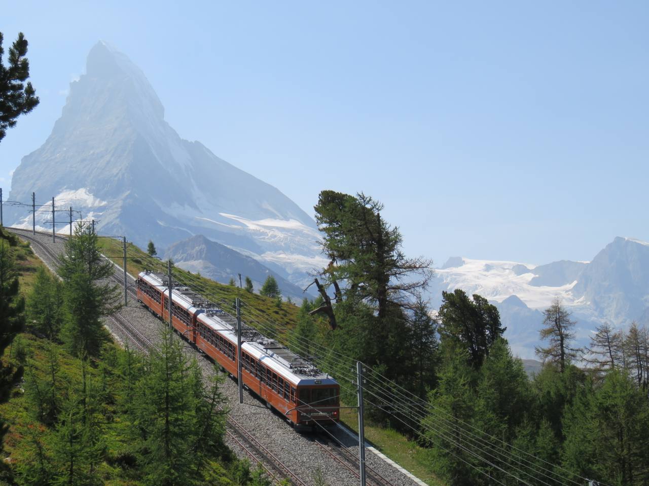A Gornergrat Railway train with the Matterhorn in the background above Zermatt.