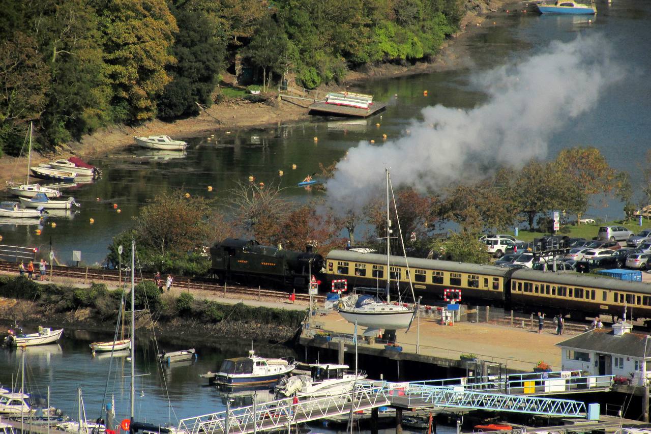 A Dartmouth Steam Railway train leaving Kingswear alongside the River Dart.