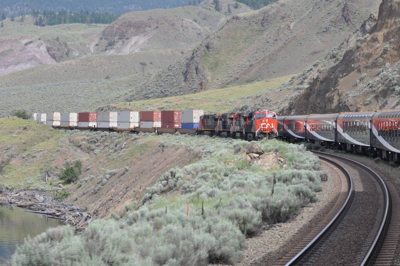 A Rocky Mountaineer train running through the dry canyon country of interior British Columbia.