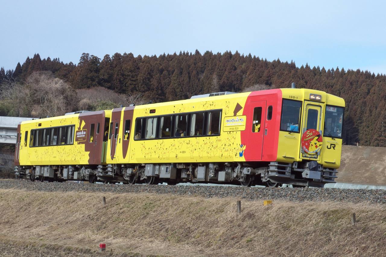 The yellow and red Pokémon with YOU Train running through rural Iwate.