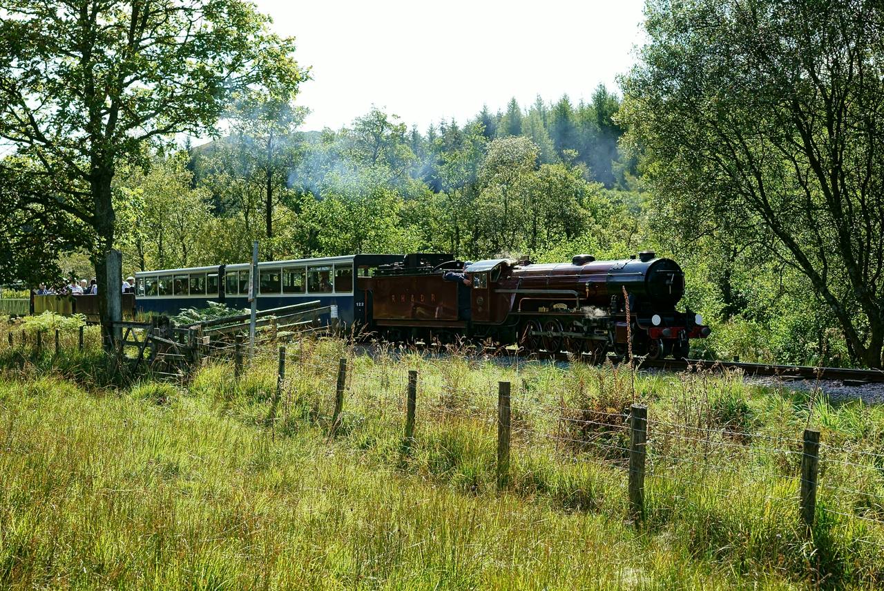 A Ravenglass and Eskdale Railway train running through the Cumbrian valley.