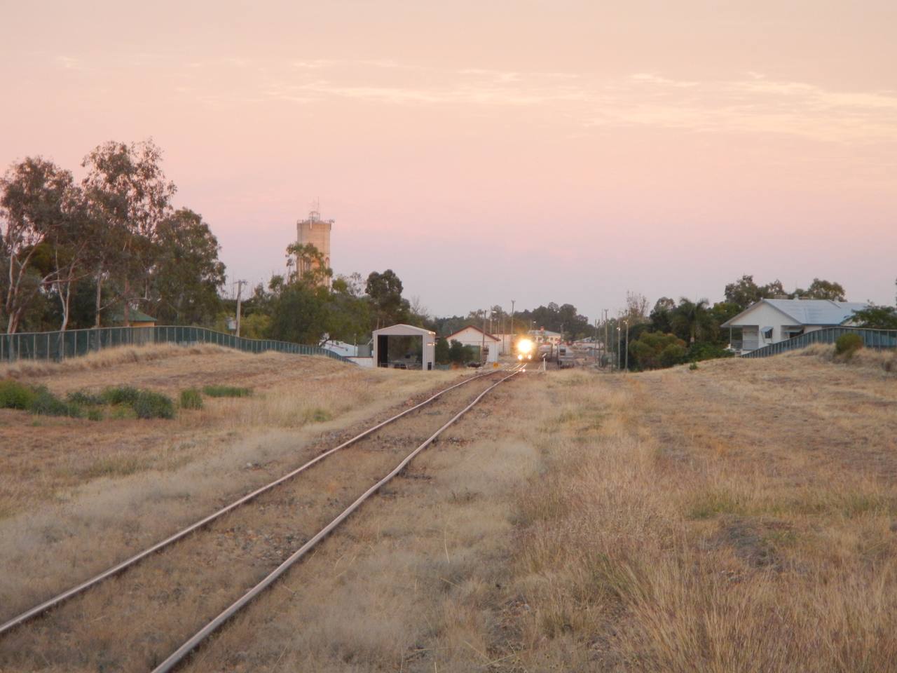 Spirit of the Outback departing Longreach across open Queensland country.