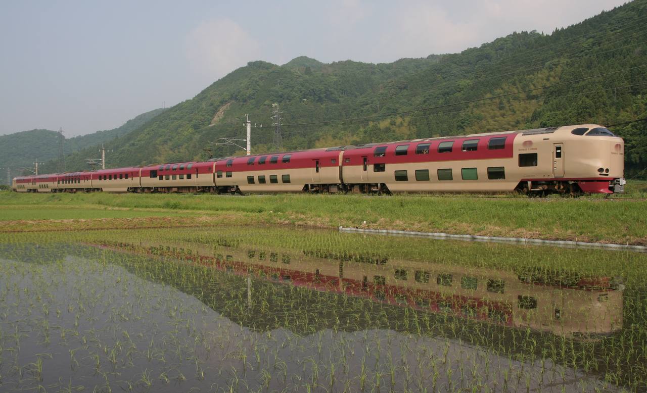 The Sunrise Izumo sleeper train passes flooded rice paddies in western Japan.