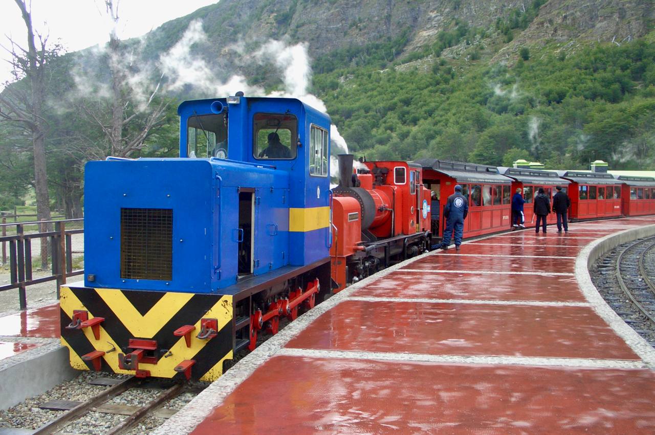 The End of the World Train stands with its coaches beneath the mountains near Ushuaia.