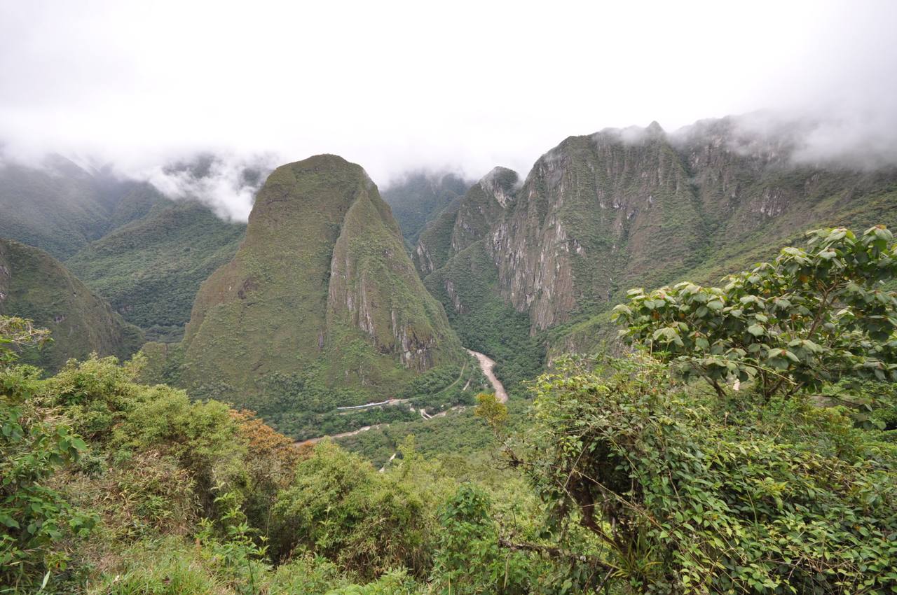 A PeruRail train beside the Urubamba River near Machu Picchu on the Vistadome Observatory route.