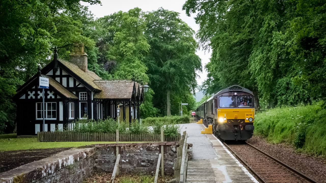 The Royal Scotsman passing Dunrobin Castle Station in the Scottish Highlands.