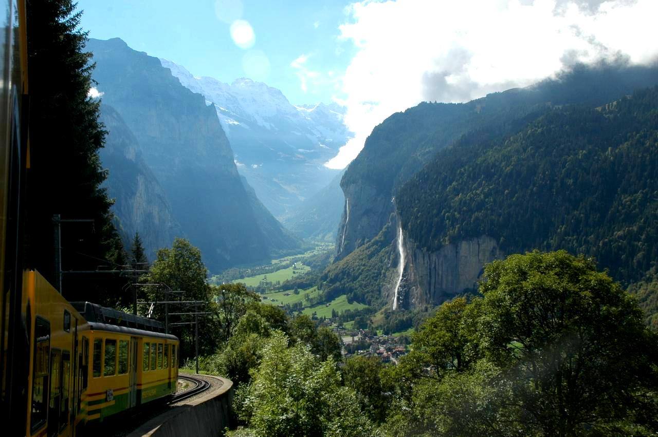 A Wengernalp Railway train climbing through the Lauterbrunnen valley toward Wengen.