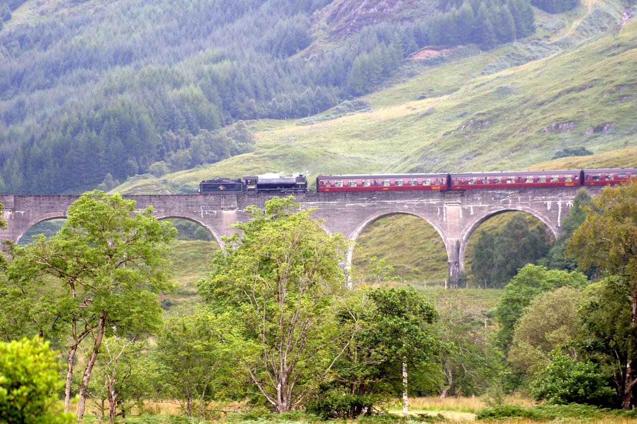 A train crossing Glenfinnan Viaduct on the West Highland Line in Scotland.